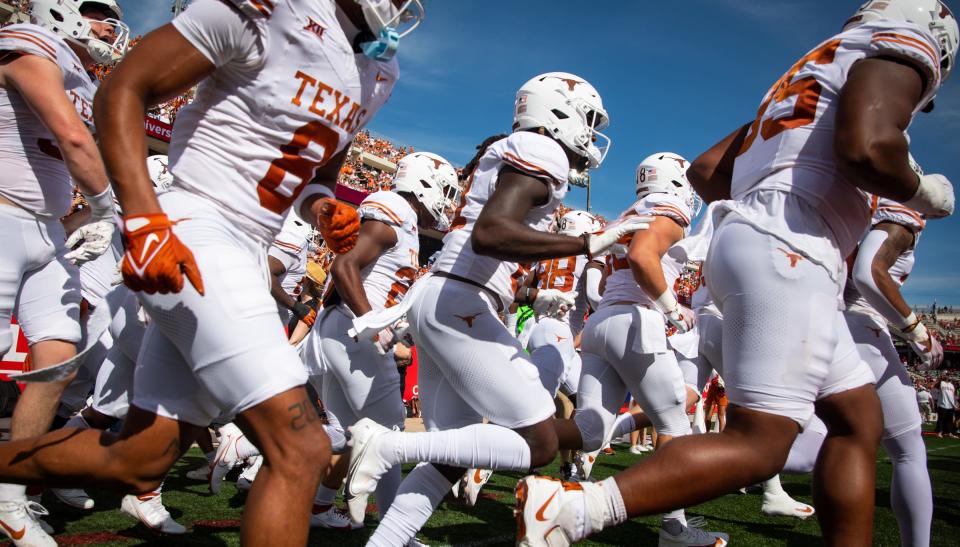 Texas players run onto the field at TDECU Stadium prior to Saturday's 31-24 win over Houston. The Longhorns improved to 6-1 on the season.