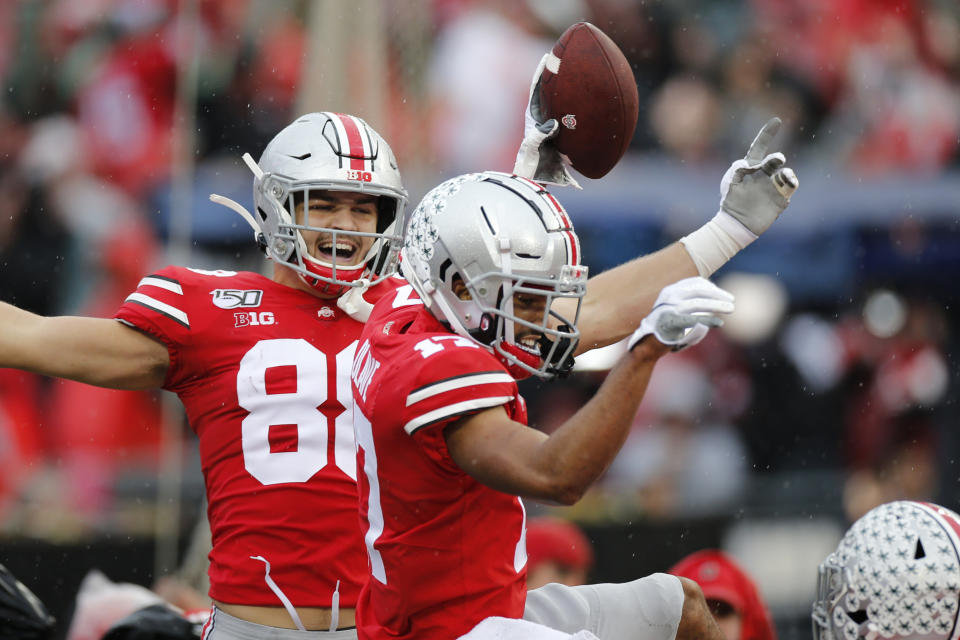 Ohio State receiver Chris Olave, right, celebrates his touchdown against Wisconsin with teammate Jeremy Ruckert during the first half of an NCAA college football game Saturday, Oct. 26, 2019, in Columbus, Ohio. (AP Photo/Jay LaPrete)