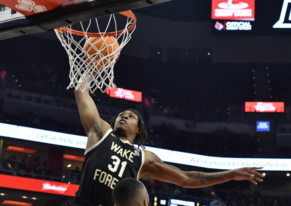 FILE - Wake Forest guard Alondes Williams (31) goes up for a dunk during the first half of an NCAA college basketball game against Louisville in Louisville, Ky., Dec. 29, 2021. There are a lot of old newcomers making big impacts in college basketball. ACC top scorer Williams for Wake Forest and Pac-12 leader Terrell Brown Jr. at Washington are both senior transfers who joined their new teams this season. (AP Photo/Timothy D. Easley, File)