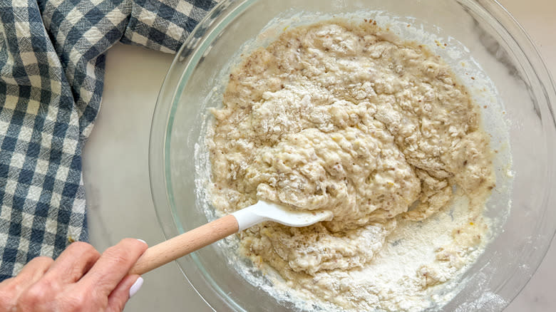 hand mixing muffin batter in bowl