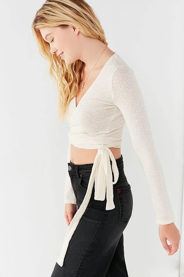 Get it <a href="https://www.urbanoutfitters.com/shop/uo-cozy-long-sleeve-cropped-wrap-top" target="_blank">here</a>.&nbsp;