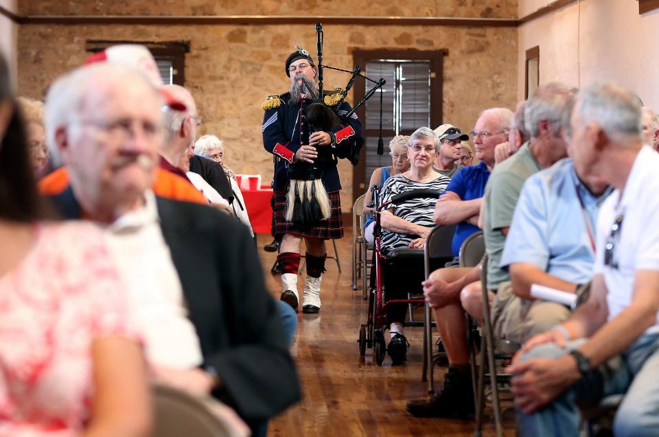 Fort Concho Education Director Chris Morgan plays the bagpipes for attendees during a speaker series event at Fort Concho in September 2015.