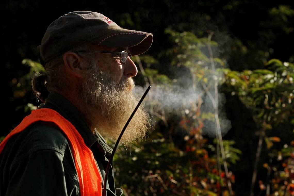 Bill Moyle listens to his walkie talkie from an overlook on South Carolina Highway 107 near Mountain Rest during an early morning bear hunt. Moyle says bear hunting is a tradition he wants to carry on. “It’s been going on a long time,” he said. “Davy Crockett killed bear.”