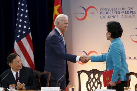 U.S. Vice President Joe Biden (C) shakes hands with Chinese Vice Premier Liu Yandong as State Councilor Yang Jiechi (L) looks on at the Strategic and Economic Dialogue (S&ED) at the State Department in Washington June 23, 2015. REUTERS/Yuri Gripas