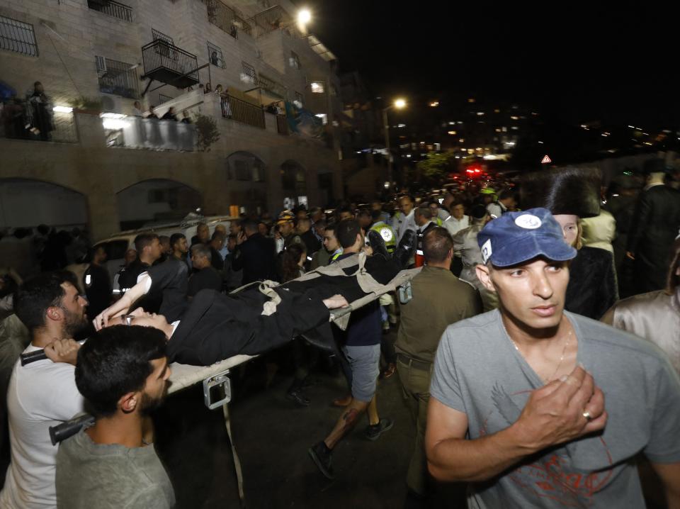 Medics and members of the Israeli security forces evacuate an injured child after the collapseAFP via Getty Images