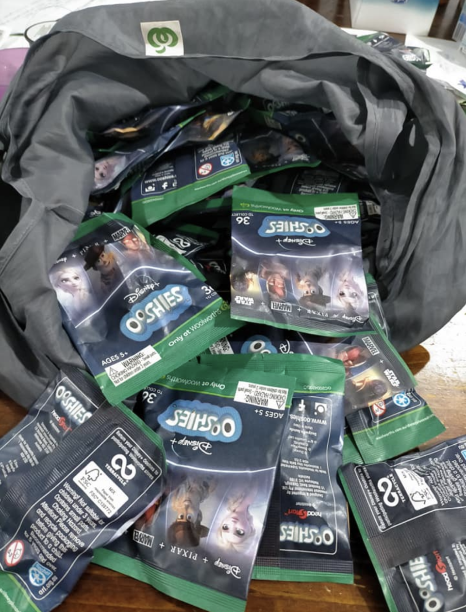 A Woolworths bag filled with Ooshie collectibles. 