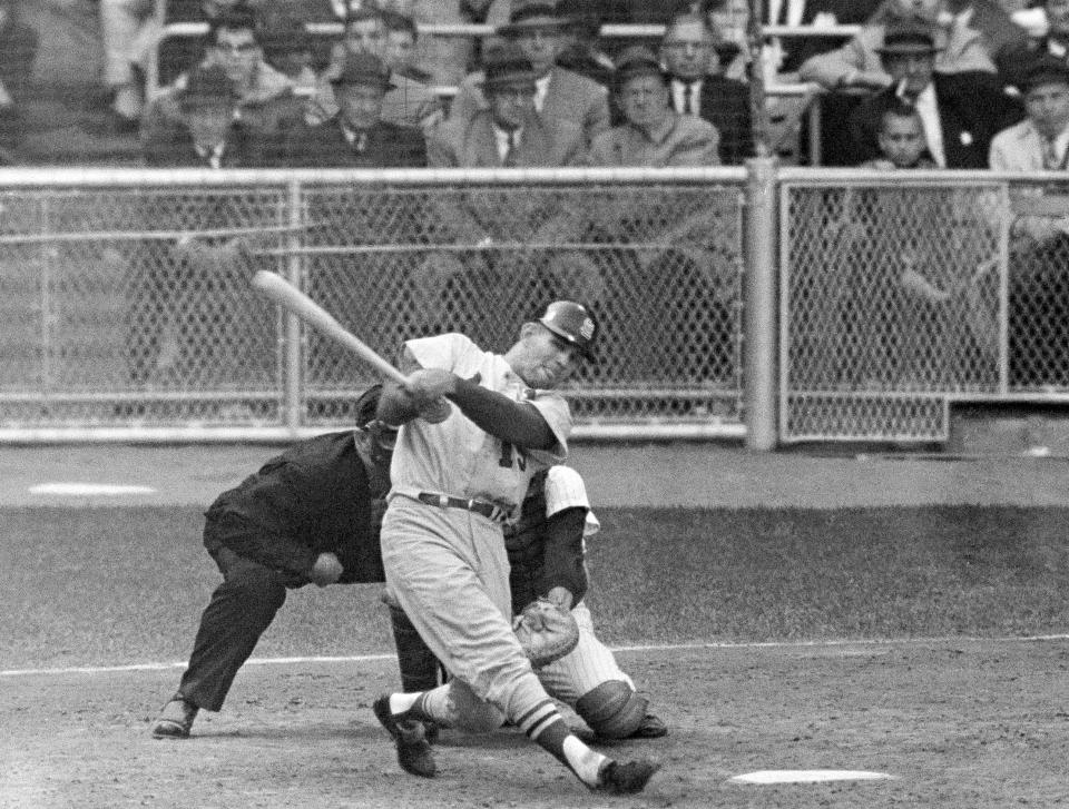 FILE - St. Louis Cardinals' Tim McCarver watches ball as he hits the game-winning home run in the 10th inning in Game 5 of the baseball's World Series against the New York Yankees on Oct. 12, 1964 in Yankee Stadium in New York. McCarver, the All-Star catcher and Hall of Fame broadcaster who during 60 years in baseball won two World Series titles with the St. Louis Cardinals and had a long run as the one of the country's most recognized, incisive and talkative television commentators, died Thursday morning, Feb. 16, 2023, in Memphis, Tenn., due to heart failure, baseball Hall of Fame announced. He was 81. (AP Photo/File)