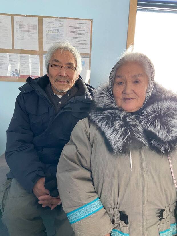 Sanikiluaq mayor Johnnie Cookie with his wife Annie. Cookie says the pandemic has shown a further need for the community to be connected to the territory and is calling for two flights a week between his community and Iqaluit.  (Submitted by Johnnie Cookie - image credit)