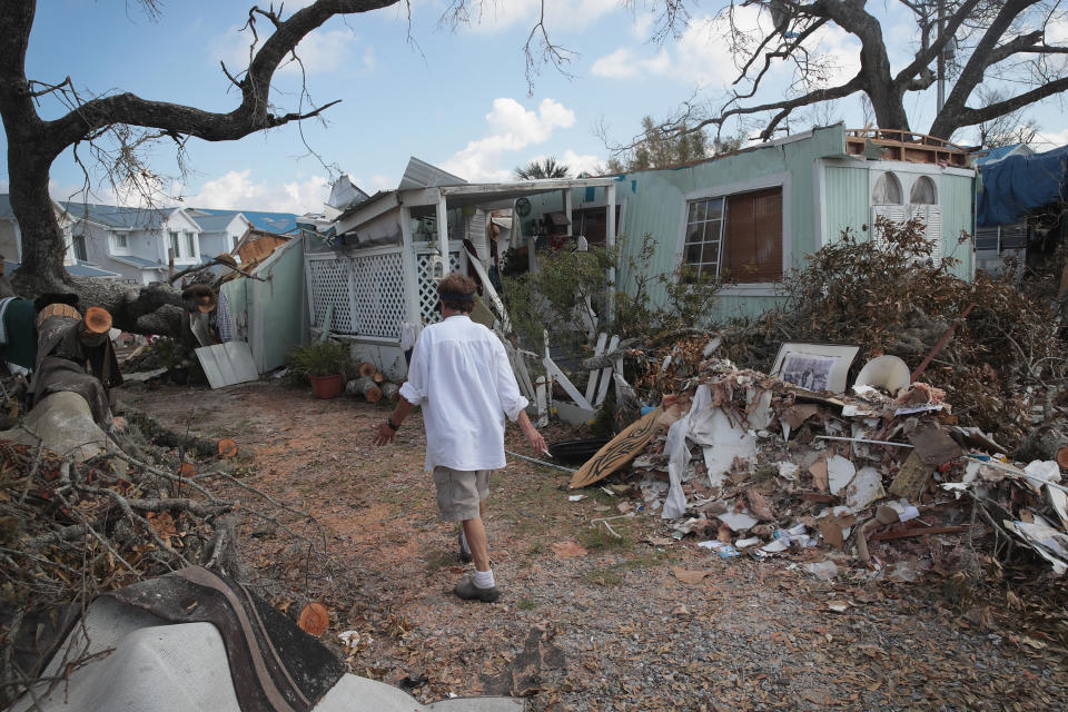 Debbie Powell of Panama City, Florida, walks to her trailer on Oct. 15 in Water's Edge RV Park, which was damaged by Hurricane Michael. (Photo: Scott Olson via Getty Images)