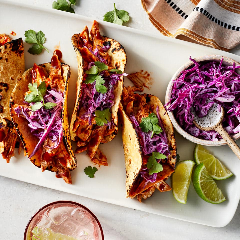 <p>This zippy, creamy slaw is so good you might find yourself making it for other sandwiches. Still, it pairs beautifully with the tangy pulled chicken for an incredibly quick dinner you can make even on your busiest nights. To save even more time, use a preshredded coleslaw blend. <a href="https://www.eatingwell.com/recipe/270288/bbq-chicken-tacos-with-red-cabbage-slaw/" rel="nofollow noopener" target="_blank" data-ylk="slk:View Recipe" class="link ">View Recipe</a></p>