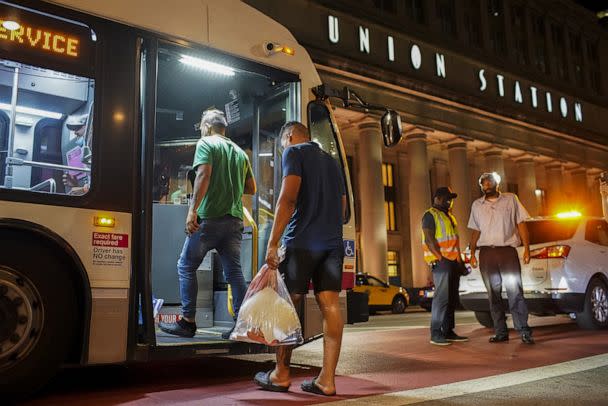 PHOTO: A group of migrants board a CTA bus at Union Station in Chicago, to be taken to a Salvation Army shelter after arriving from Texas on Aug. 31, 2022. (Armando L. Sanchez/Chicago Tribune/TNS via Getty Images)