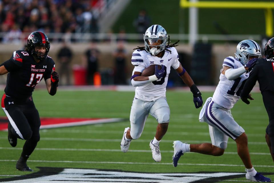 Kansas State running back Treshaun Ward (9) carries the ball while Texas Tech's Ben Roberts (13) gives chase during last Saturday's game at Jones AT&T Stadium in Lubbock, Texas.
