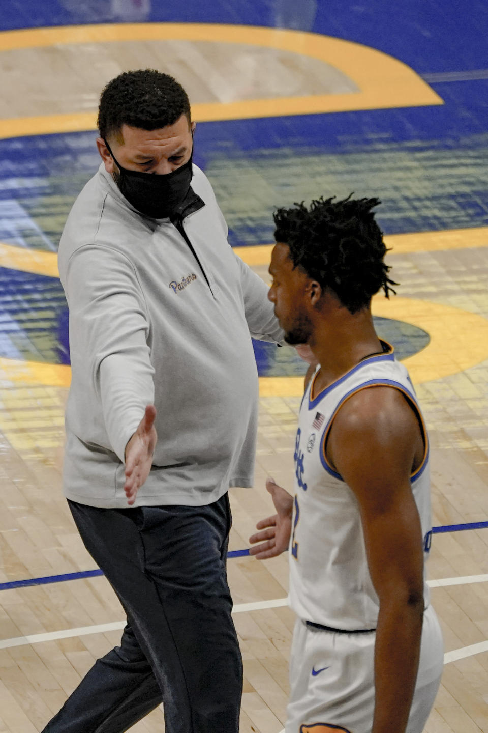 Pittsburgh head coach Jeff Capel, left, greets Au'diese Toney (5) during a timeout in the first half of an NCAA college basketball game against Syracuse, Saturday, Jan. 16, 2021, in Pittsburgh. Pittsburgh won 96-76. (AP Photo/Keith Srakocic)