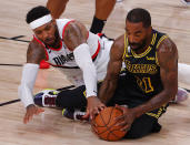 Los Angeles Lakers' JR Smith (21) and Portland Trail Blazers' Carmelo Anthony, left, go after the ball during the second quarter of Game 4 of an NBA basketball first-round playoff series, Monday, Aug. 24, 2020, in Lake Buena Vista, Fla. (Kevin C. Cox/Pool Photo via AP)