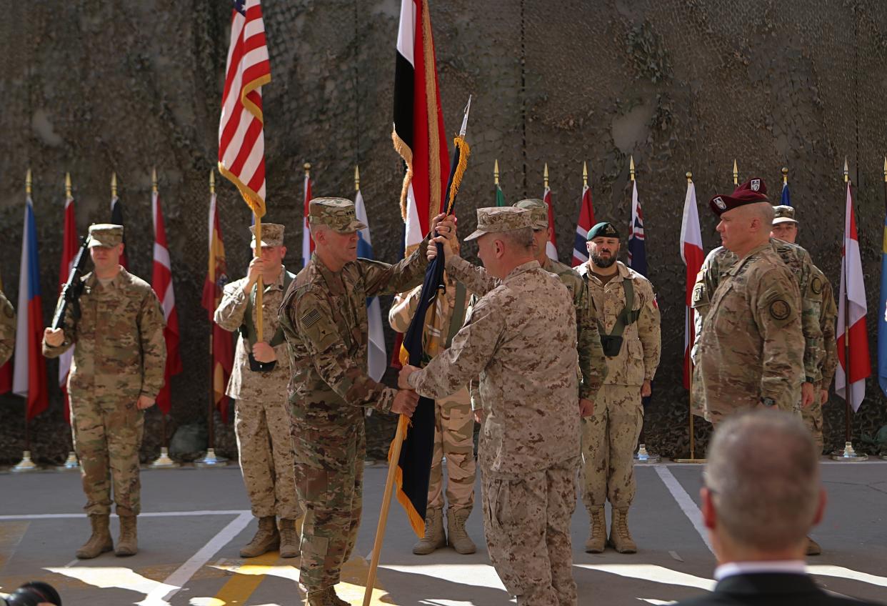 FILE - In this Sept. 14, 2019, file photo U.S. Army Lt. Gen. Pat White, III Armored Corps Commanding General, center left, and Commanding General for U.S. Central Command Gen. Kenneth F. McKenzie Jr. center right, take part in a transfer authority ceremony at Union III, base in Baghdad, Iraq, Saturday, Sept. 14, 2019. White is the Fort Hood commander and he is facing the grim task of rebuilding trust and turning around an installation that has one of the highest rates of murder, sexual assault and harassment in the Army. (AP Photo/Khalid Mohammed, File)