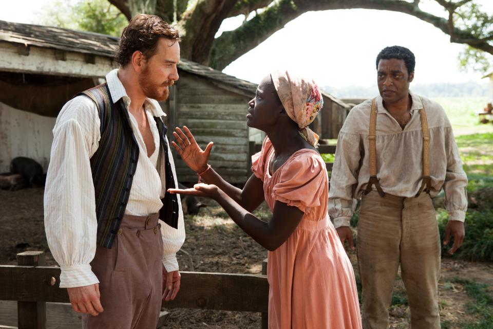 Michael Fassbender, Lupita Nyong'o and Chiwetel Ejiofor act in a scene from the 2012 film "12 Years A Slave."