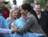 Meghan, Duchess of Sussex is embraced by a local woman during a visit to a community picnic at Victoria Park in Dubbo, Australia, Wednesday, Oct. 17, 2018. Prince Harry and his wife Meghan are on day two of their 16-day tour of Australia and the South Pacific. (Ian Vogler/Pool via AP)