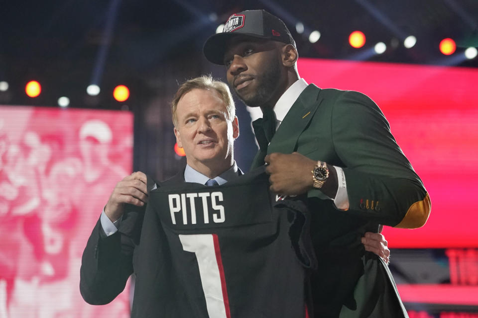 Florida tight end Kyle Pitts, right, holds a jersey with NFL Commissioner Roger Goodell after he was chosen by the Atlanta Falcons with the fourth pick in the NFL football draft, Thursday, April 29, 2021, in Cleveland. (AP Photo/Tony Dejak)
