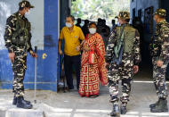 Voters leave a polling station after casting their votes during the fourth phase of West Bengal state elections in Kolkata, India, Saturday, April 10, 2021. (AP Photo/Bikas Das)