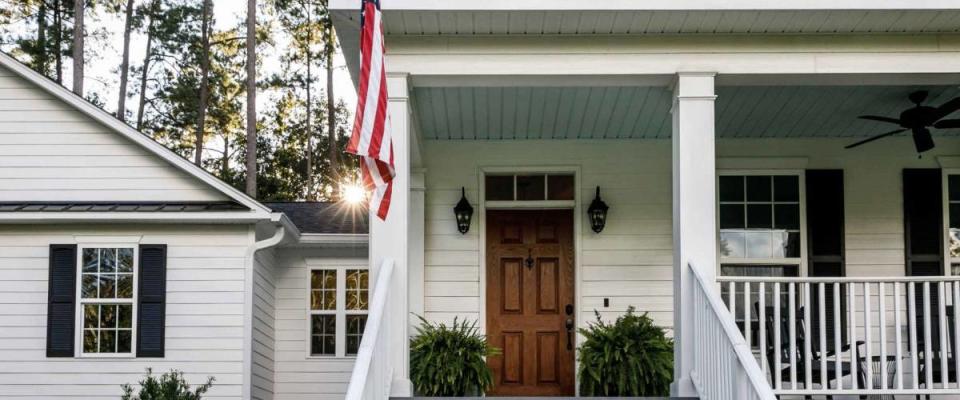 Front Porch with Stairs of All American White Farmhouse with Wood Doors