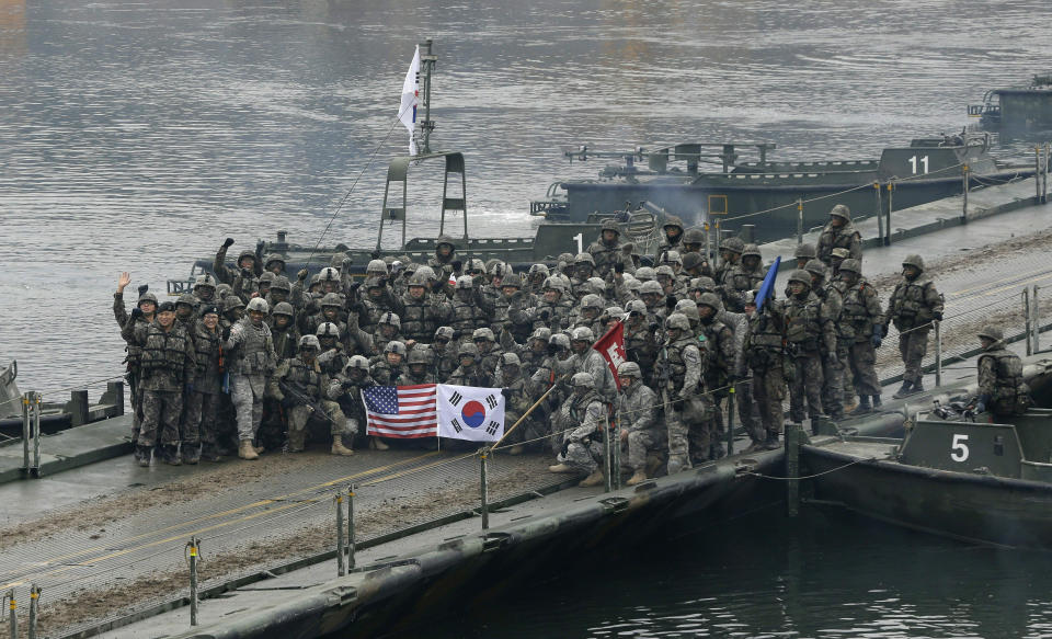 FILE - In this Dec. 10, 2015, file photo, U.S. and South Korean army soldiers pose on a floating bridge on the Hantan river after a river crossing operation, part of an annual joint military exercise between South Korea and the United States against a possible attack from North Korea, in Yeoncheon, south of the demilitarized zone that divides the two Koreas, South Korea. Competing interests swirl as Donald Trump and Kim Jong Un meet in Hanoi to put flesh on what many critics call their frustratingly vague first summit in Singapore. (AP Photo/Ahn Young-joon, File)