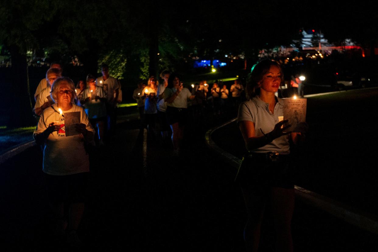 Fans make their way up the lawn of Graceland to the Meditation Garden with their candles to pay respects to the Presley family members buried there during the annual Candlelight Vigil to honor Elvis Presley in Memphis, Tenn., on Thursday, August 15, 2024.