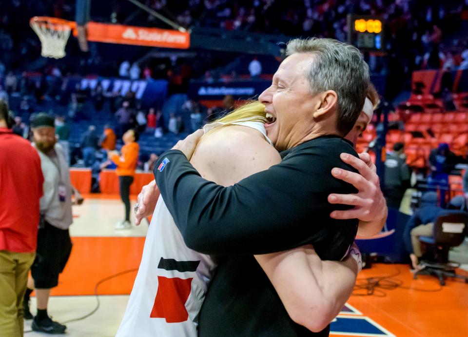 Metamora head coach Danny Grieves hugs senior Ethan Kizer after the Redbirds' 50-43 victory over East St. Louis in the Class 3A basketball state semifinals Friday, March 10, 2023 at State Farm Center in Champaign.