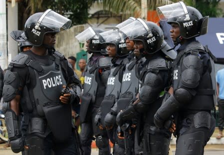 Police officers stand guard during a protest against corruption and economic failure in Monrovia