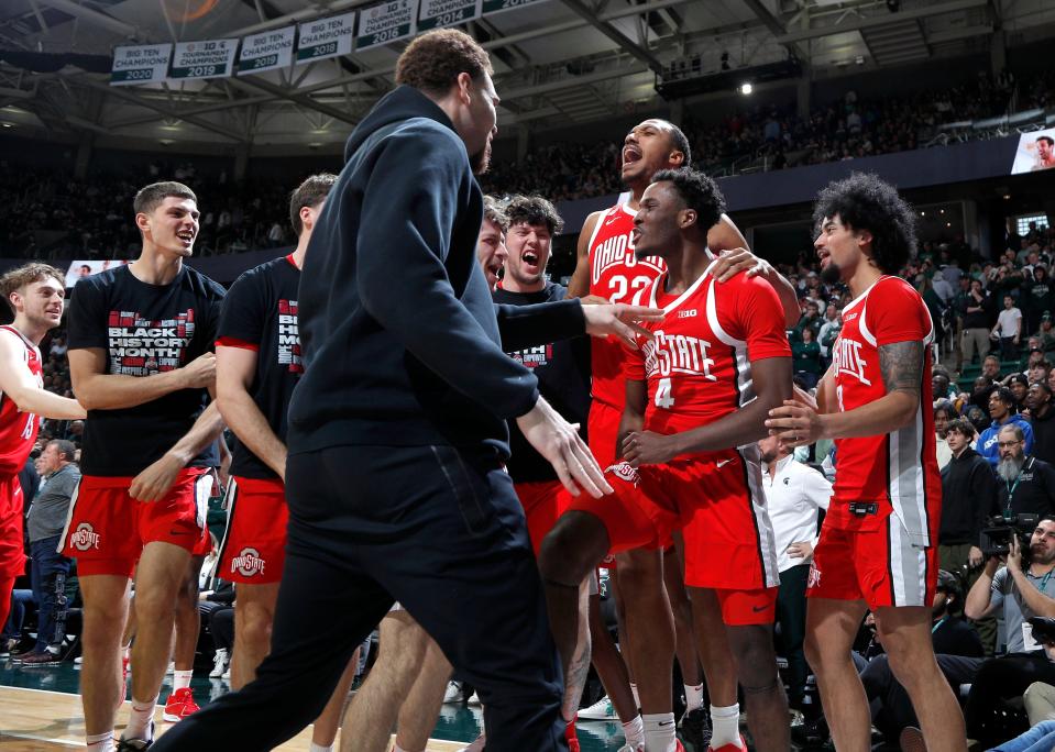 Ohio State players, including guard Dale Bonner (4), celebrate after Bonner hit the winning 3-point basket in the closing seconds against Michigan State at Breslin Center in East Lansing on Sunday, Feb. 25, 2024.