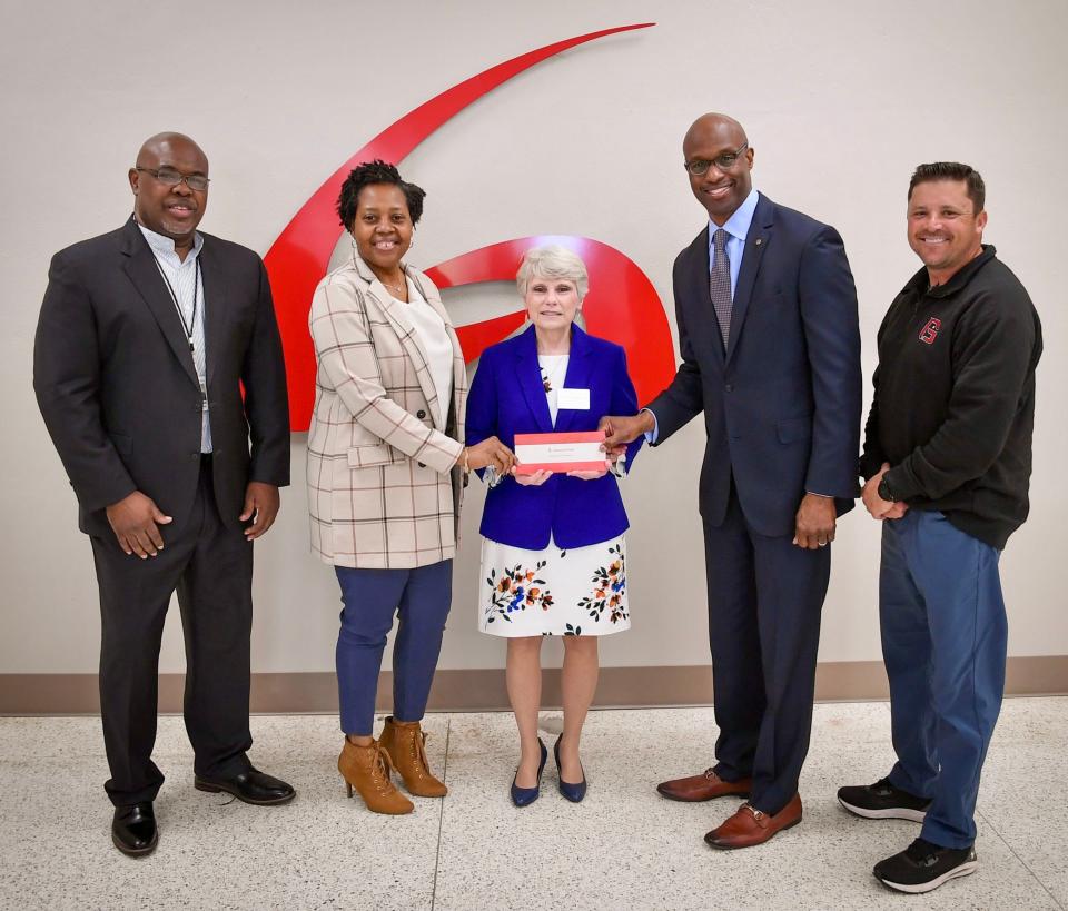 A $50,000 grant check from Alabama Power Co. was presented to Kathy Murphy, middle, president of Gadsden State Community College, and to Blake Lewis, far right, athletic director, for the construction of a new walking and running trail on the school’s Wallace Drive Campus. Also pictured are, from left, Spencer Williams, Alabama Power’s community relations manager in Etowah County; Dana McFarland, community relations manager in Calhoun County; and Terry Smiley, vice president of the company’s Eastern Division.