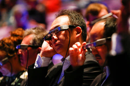 People watch a live performance of Exit the King at the National Theatre while wearing Smart Caption Glasses, designed by Epson, in London, Britain, October 3, 2018. REUTERS/Henry Nicholls