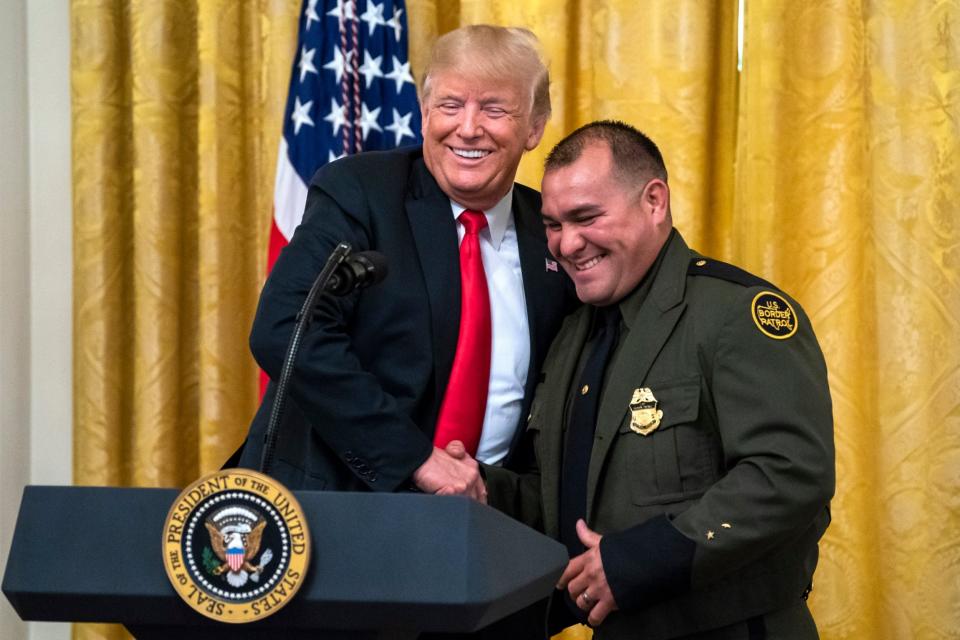 Mr Trump called a Border Patrol agent up to speak during his White House event: EPA