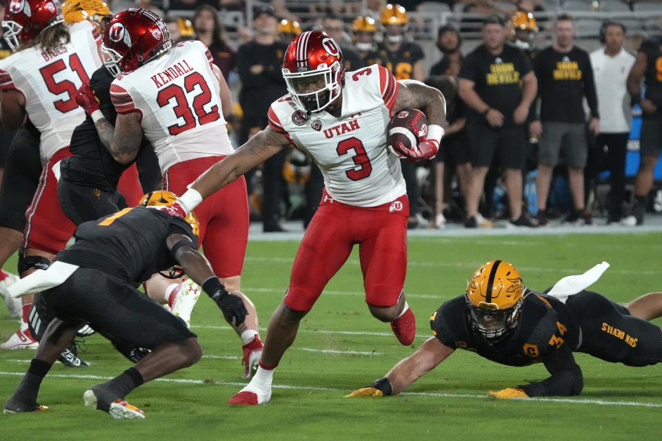 Utah quarterback Ja'Quinden Jackson (3) runs the ball between Arizona State defensive back Jordan Clark (1) and linebacker Kyle Soelle (34) during the first half of an NCAA college football game Saturday, Sept. 24, 2022, in Tempe, Ariz. (AP Photo/Rick Scuteri)