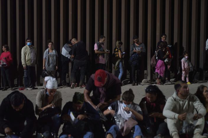 Migrants wait to be processed by US Border Patrol after illegally crossing the US-Mexico border in Yuma, Arizona in the early morning of July 11, 2022.&nbsp; / Credit: ALLISON DINNER/AFP via Getty Images