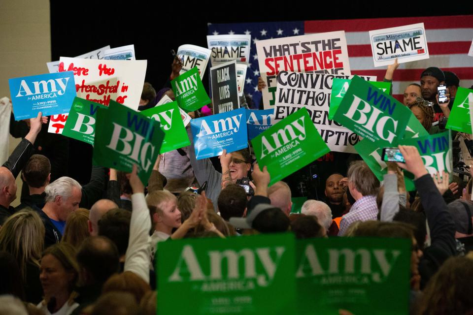 Supporters face off with protestors who took over the stage forcing Democratic presidential hopeful Minnesota Senator Amy Klobuchar to cancel her rally before it even started on March 1, 2020 in St. Louis Park, west of Minneapolis, Minnesota. - Hundreds of Klobuchar supporters witnessed a group of Black Lives Matter protesters demanding her to drop out of the race after her misshandling of Myon Burrell's case in 2002 when she was County Attorney. (Photo by Kerem Yucel / AFP) (Photo by KEREM YUCEL/AFP via Getty Images)