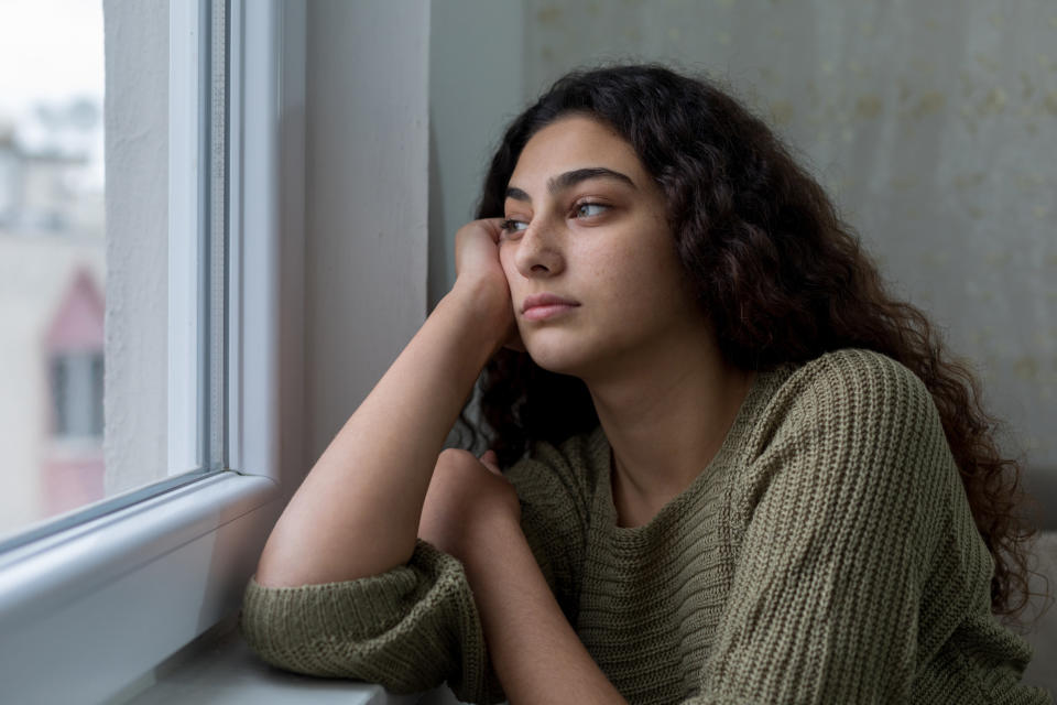 woman looking out a window