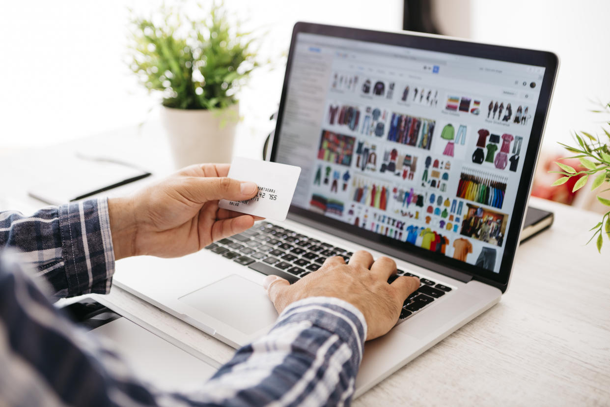 Man enters credit card information while shopping online