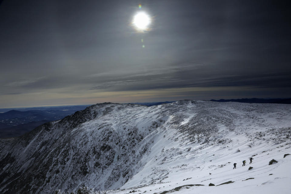 Under a midday winter solstice sun, a trio of climbers make their way up a slope on Mount Washington, Saturday, Dec. 21, 2019, in New Hampshire. Neither the sun nor the mercury rose very high as temperatures barely climbed out of the single digits on the shortest day of the year. The mountain had just 8 hours and 51 minutes of daylight on Saturday. (AP Photo/Robert F. Bukaty)