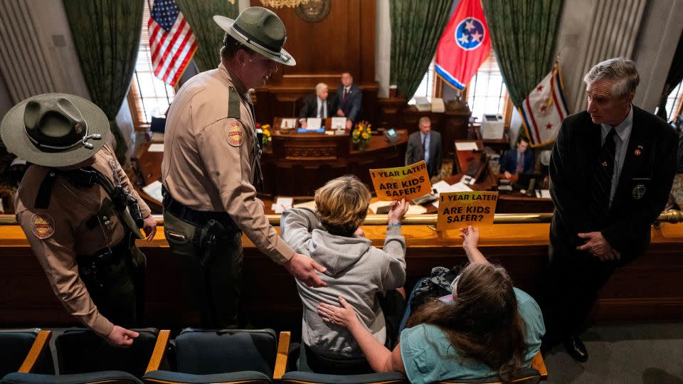 Tennessee State Troopers ask gun reform activists to clear the state Senate gallery. - Seth Herald/Reuters