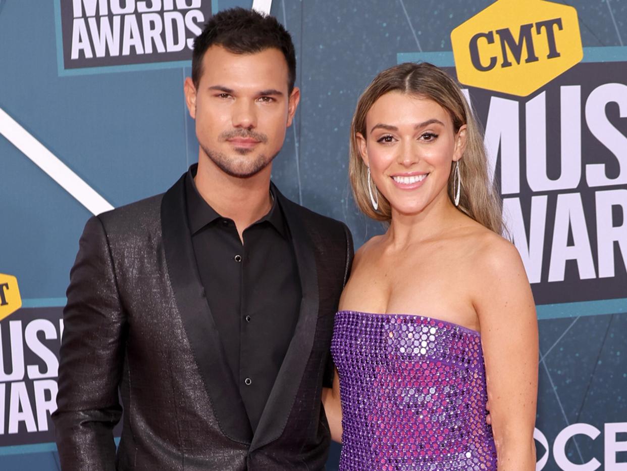 Taylor Lautner and Taylor Dome attend the 2022 CMT Music Awards at Nashville Municipal Auditorium on April 11, 2022 in Nashville, Tennessee