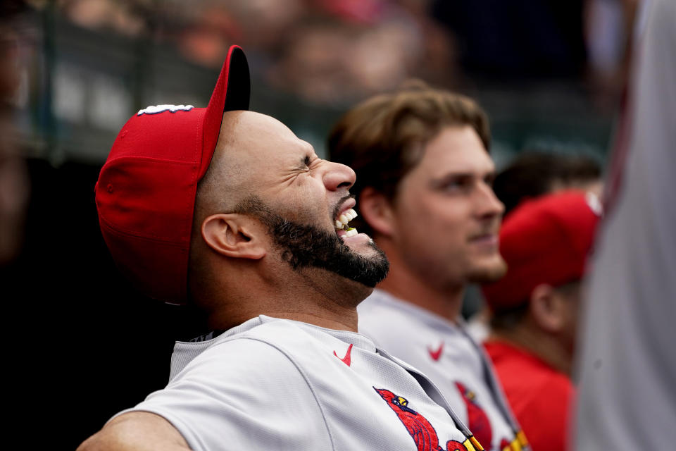 St. Louis Cardinals' Albert Pujols laughs in the dugout during the eighth inning of a baseball game against the Chicago Cubs Thursday, Aug. 25, 2022, in Chicago. (AP Photo/Charles Rex Arbogast)