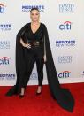 <p>Katy looked tres chic wearing this insane caped jumpsuit to a benefit concert in 2015. [Photo: Getty] </p>