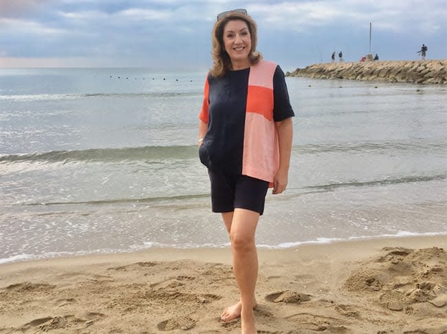 Jane McDonald stood on the beach