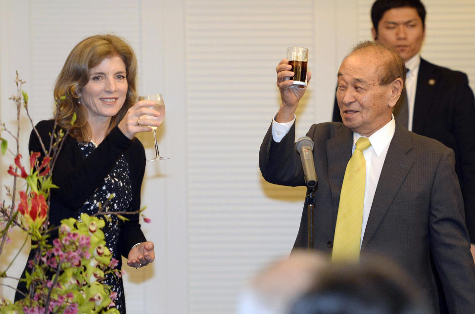 U.S. Ambassador to Japan Caroline Kennedy, left, toasts with Okinawa Gov. Hirokazu Nakaima at a reception in Naha, Okinawa Wednesday, Feb. 12, 2014. Kennedy has made her first visit to the southernmost island of Okinawa, hoping to get support for a controversial plan to relocate a U.S. military base. (AP Photo/Kyodo News) JAPAN OUT, MANDATORY CREDIT