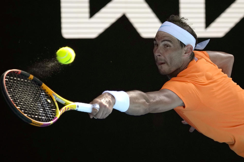 Rafael Nadal of Spain plays a backhand return to Jack Draper of Britain during their first round match at the Australian Open tennis championship in Melbourne, Australia, Monday, Jan. 16, 2023. (AP Photo/Aaron Favila)