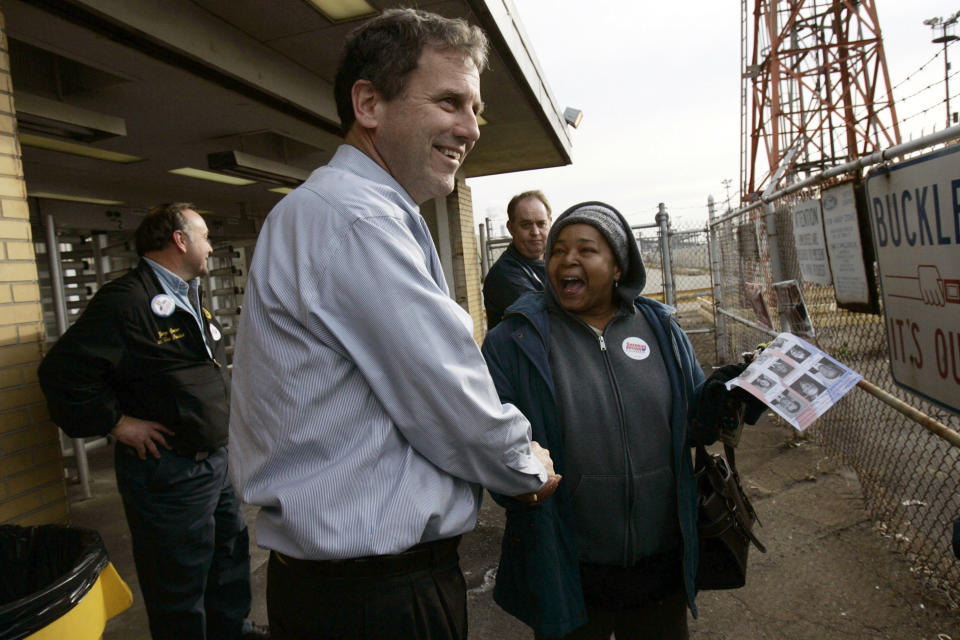 Brown shakes hands with workers as they leave the Ford Engine Plant in 2006 in Brook Park, Ohio. (Photo: Jamie Rose/Getty Images)