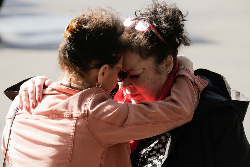 Carmen Gray hugs her sister, Bridget Parkhill, after discussing concerns about coughing exhibited by their mother, Susan Hailey, who is a resident at the Life Care Center of Kirkland