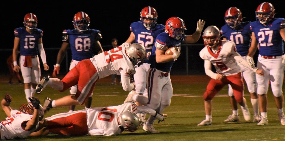 New Hartford Spartan Cole Raux works his way through a series of Carthage defenders during Friday's Section III playoff game. The senior topped 200 yards for the seventh time this season and pushed his total over 2,000.