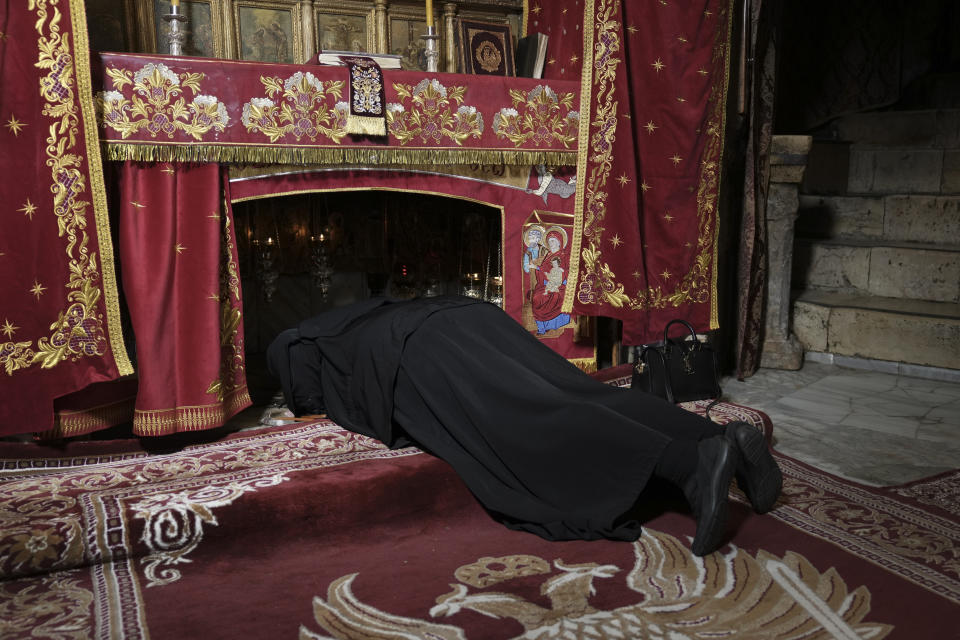 A nun kisses the place where Christians believe Jesus Christ was born on the eve of the Orthodox Christmas in the Church of the Nativity in Bethlehem, West Bank, Saturday, Jan. 6, 2024. (AP Photo/Mahmoud Illean)