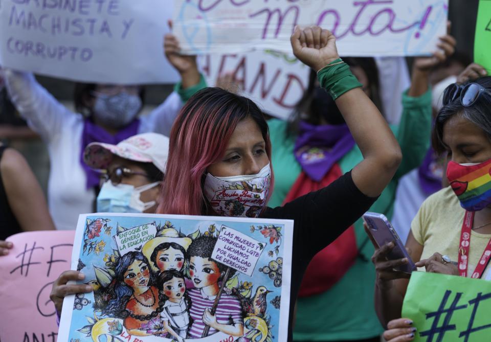 Feminist groups protest against what they call a "machista" and corrupt Cabinet of Peru’s President Pedro Castillo, outside the Ministry of Women, in Lima, Peru, Friday, Feb. 4, 2022. The women called out Peru’s newly appointed prime minister Hector Valer, head of the Cabinet, who has been accused of domestic violence against his wife and daughter. Valer has denied the accusations. (AP Photo/Martin Mejia)